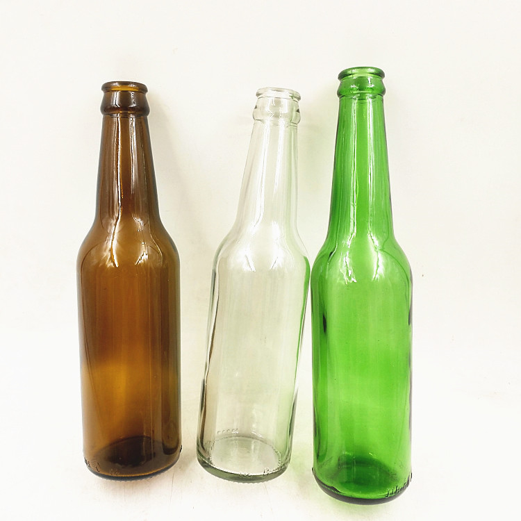 Empty 330ml clear amber green glass beer bottle with 26mm crown cap