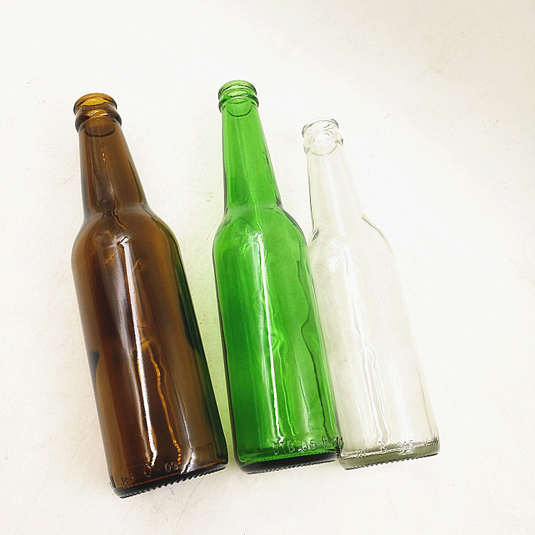 Empty 330ml clear amber green glass beer bottle with 26mm crown cap