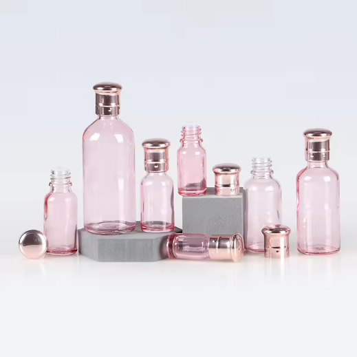 Customized color 30ml 50ml 100ml clear pink essential oil glass bottle with rose golden cap