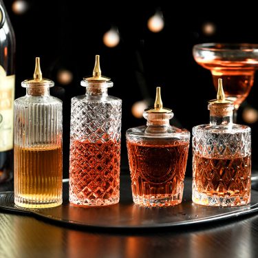 Luxury Transparent Embossed Wine Bottle Glass Bottle Whiskey Red Wine Packaging Empty Glass Oil Bottle with Oil Nozzle