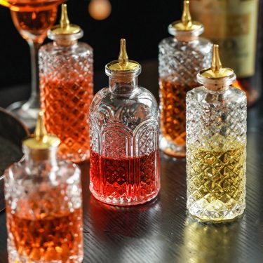 Luxury Transparent Embossed Wine Bottle Glass Bottle Whiskey Red Wine Packaging Empty Glass Oil Bottle with Oil Nozzle
