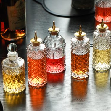 Luxury Transparent Embossed Wine Bottle Glass Bottle Whiskey Red Wine Packaging Empty Glass Oil Bottle with Oil Nozzle