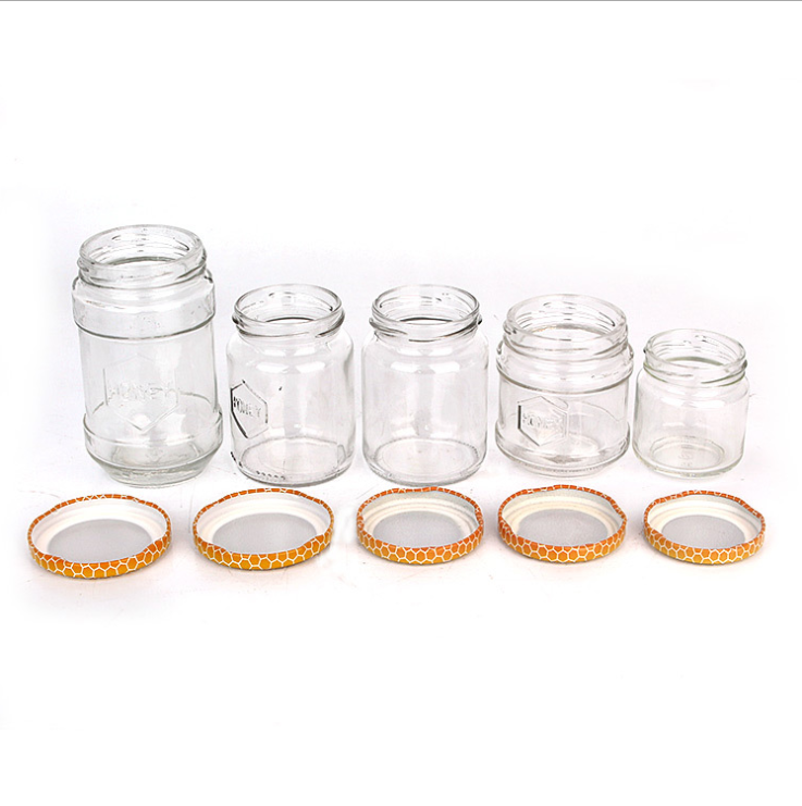 150ml 180ml 300ml 600ml 700ml Iraq Hot Sale Round Shape Bee Honey Glass Container Jar With Honeycomb Printed Lids