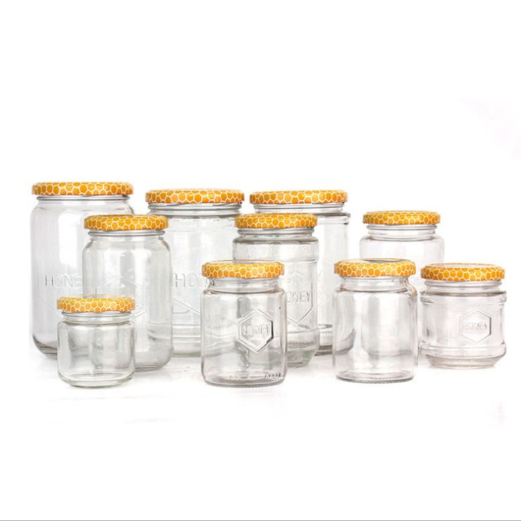 150ml 180ml 300ml 600ml 700ml Iraq Hot Sale Round Shape Bee Honey Glass Container Jar With Honeycomb Printed Lids